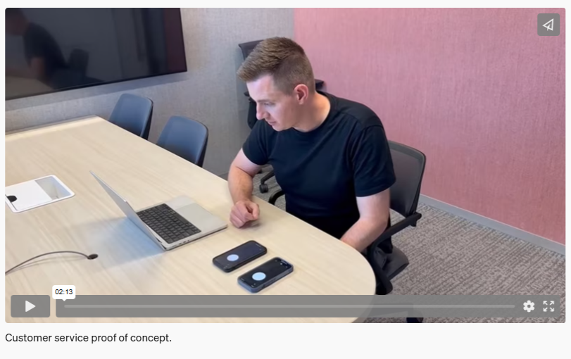 图片展示了一位男士坐在办公桌前,桌上有笔记本电脑、平板电脑和两部手机。他正专注地看着电脑屏幕。背景为室内环境,有椅子、墙面和一块显示屏。图片下方有“Customer service proof of concept.”字样。该图片与文档中“案例三:虚拟客服”内容相关,直观呈现了电商平台使用GPT - 4+数字人组合为客户提供24小时不间断虚拟客服服务的场景,体现了虚拟客服在实际工作中的应用。