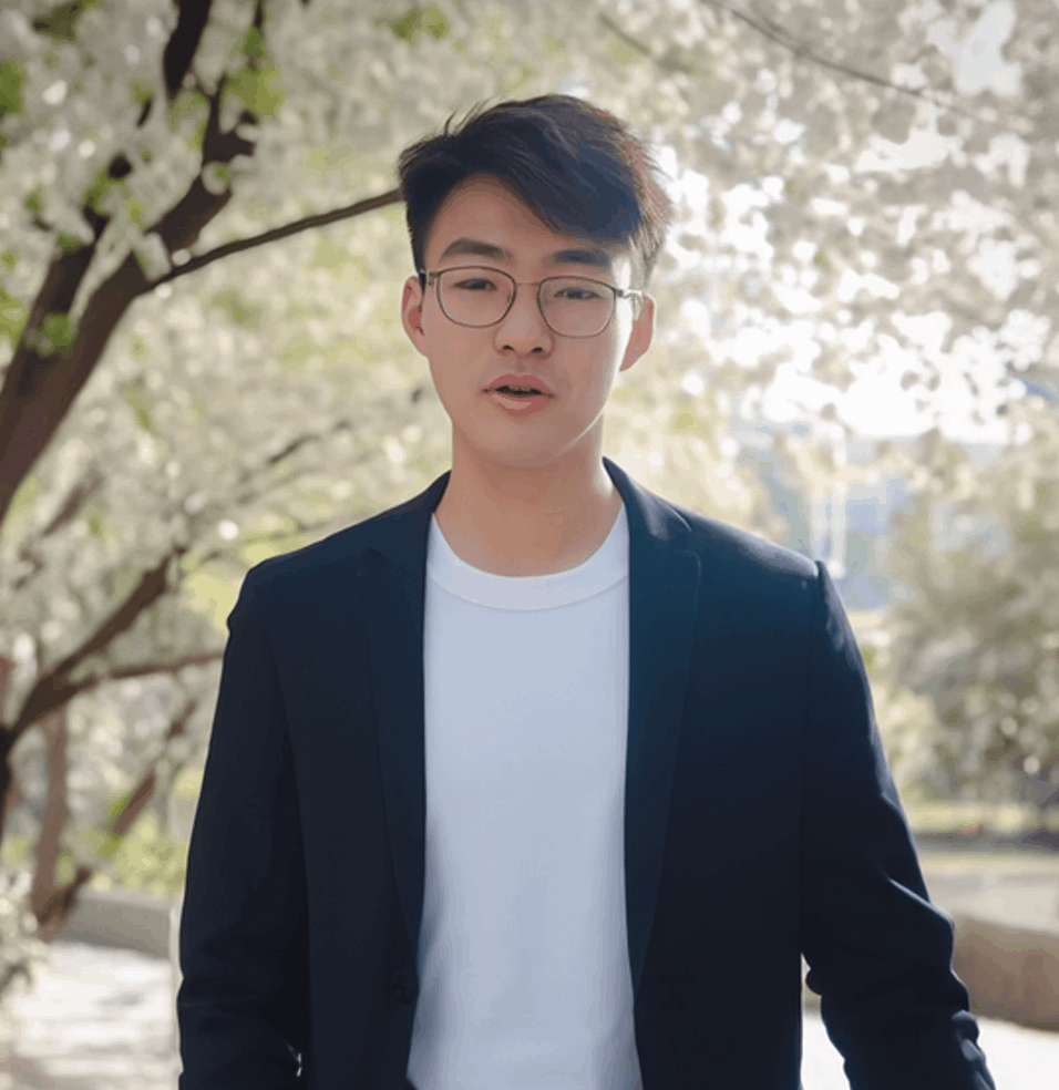 图片展示的是HeyGen内置数字人形象,为一位戴眼镜的年轻男性,身着黑色西装外套搭配白色T恤,背景是户外场景,有树木和花朵。该图片与文档中“HeyGen内置数字人可以有手势”的内容相关,用于说明HeyGen已内置多种虚拟形象,可选择自己喜欢的形象进行视频制作,为后续视频剪辑和发布做准备。