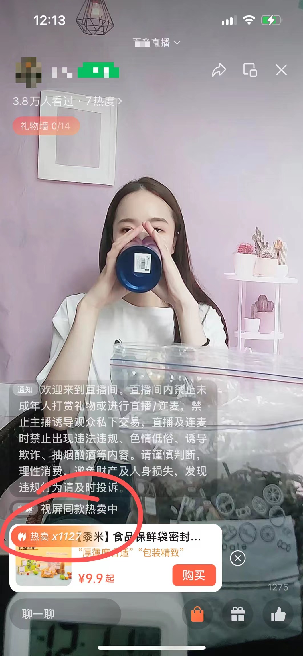 图片展示的是一场带货直播画面。画面中女主播正在用手中的蓝色容器喝水,背景为粉色墙面及白色置物架。屏幕下方有商品推荐栏,标注“热卖x112【装米】食品保鲜密封罐...”,售价9.9元起,并有“包装精致”的评价。左上角显示有3.8万人看过,还标注了“礼物榜0/14”。该图片与上下文关系为:作为案例展示,印证上文提到的数字人口播带货中直播带货环节,体现带货商品及直播相关数据情况。